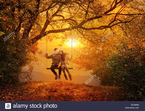 Romantic Couple Swing In The Autumn Park Stock Photo Alamy