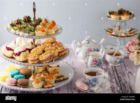 High Tea Or Afternoon Tea Laid Out On A Table With Traditional Cups