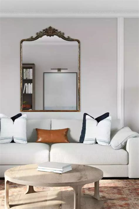 A Glam Antique Brass Mirror Immediately Catches The Eye In This Modern