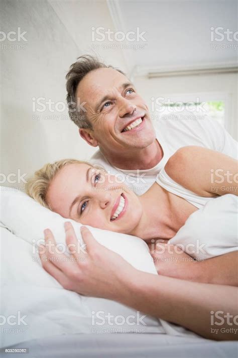 Cute Couple Cuddling In Bed Stock Photo Download Image Now 30 34