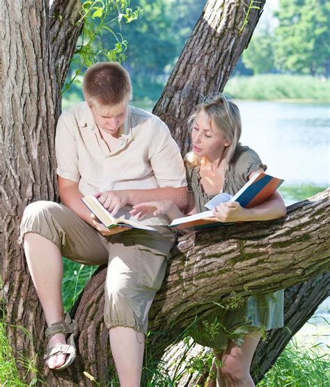 Two Teenagers Read Books Outdoors Stock Photo Image Of Friends Pond