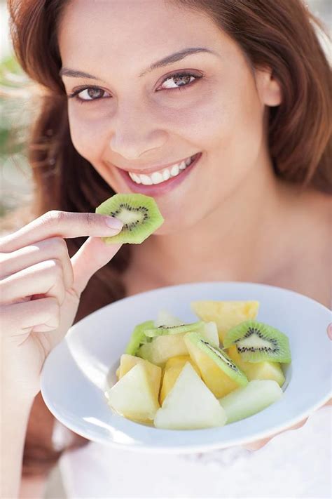 Woman Eating Fruit Photograph By Ian Hooton Science Photo Library