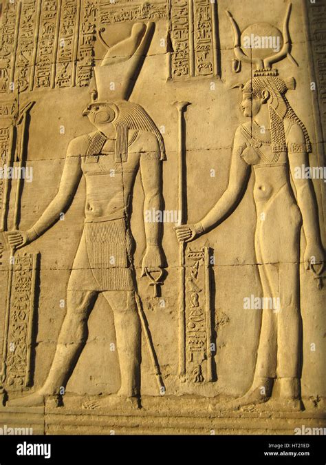 a relief depicting the god horus and the goddess hathor on the wall of one of the temples of