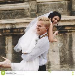 Groom Carries Bride In His Arms Stock Image - Image of laugh, caucasian: 72754577