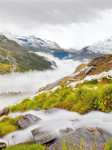 First Snow In Alps Touristic Region Fresh Green Meadow With Rapids