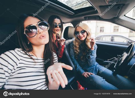 Group Of Girls Having Fun In The Car And Taking Selfies With Camera On
