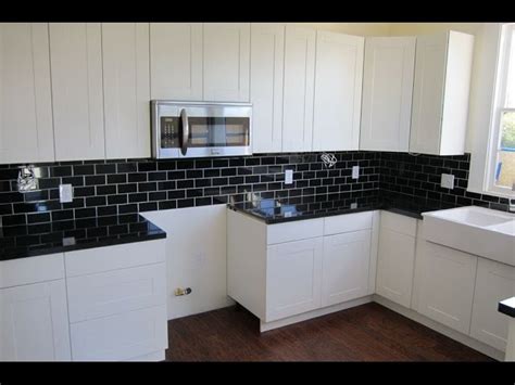 Black and white mosaic kitchen backsplash Backsplash Ideas For Black Granite Countertops And White Cabinets | Granite Karma LLC