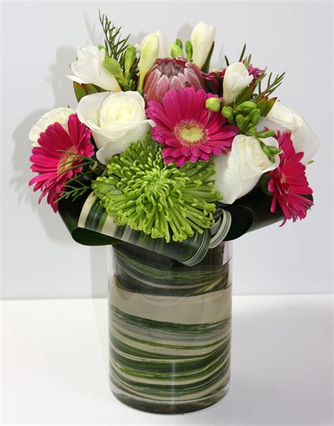 They flourish in a wide range of colors and different shades. Hot pink Gerbera daisies, white Roses, Freesia, green ...