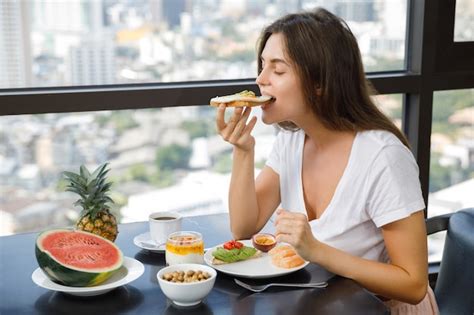 Premium Photo Young Woman Eating Breakfast At Morning