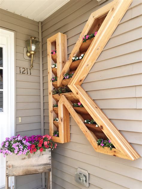 Crafting the tall porch planters is both easy and complex. Remodelaholic | DIY Monogram Planter Tutorial