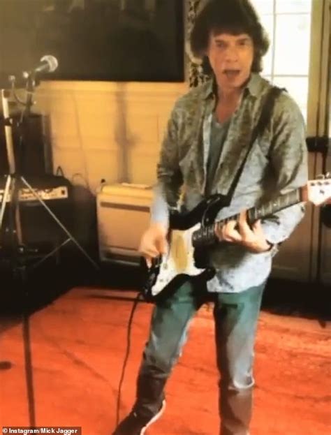 Mick Jagger Looks Happy And Healthy As He Plays The Electric Guitar