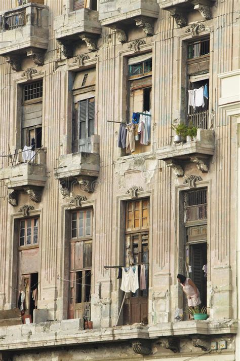 Woman Looking Out Window At Laundry Of Dilapidated Balcony In Havana