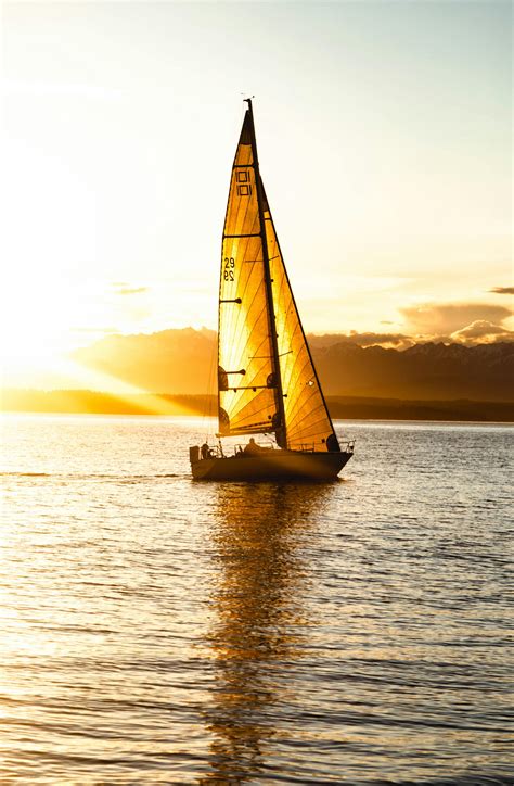 Silhouette Of Sailboat On Sea During Sunset · Free Stock Photo
