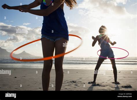 Young Women On Beach Using Hula Hoops Stock Photo Alamy