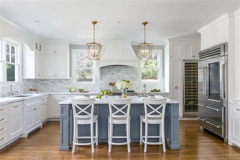 Here, mckinley architects pairs a stunning blue tile backsplash with crisp white cabinetry. Light Blue Kitchen Island with White Cabinets - Iowa Remodels