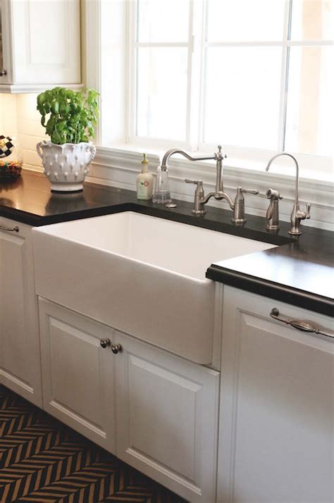 White cabinets with black countertops, a blue kitchen island with a white countertop and a wooden part seem very contrasting. Paneled Dishwashers - Transitional - kitchen - The Willows ...