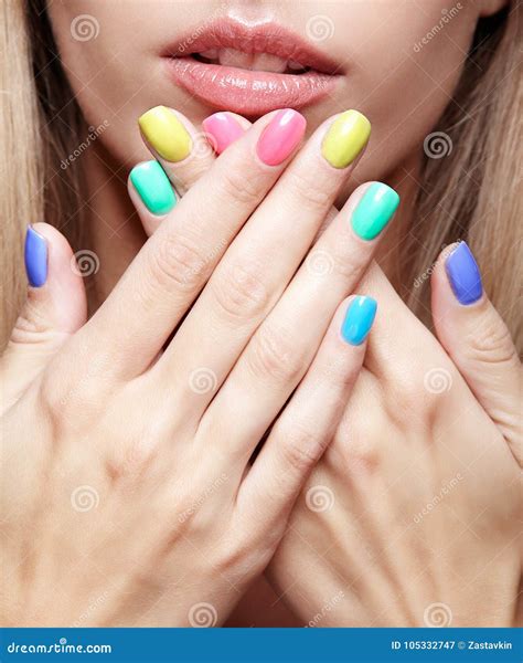 Young Blonde Woman With Fun Varicoloured Finger Nails Manicure Stock