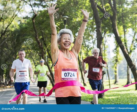 Happy Senior Running Through The Finish Line Stock Image Image Of