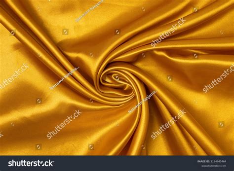 Swirled Goldcolored Fabric Texture Background This Stock Photo