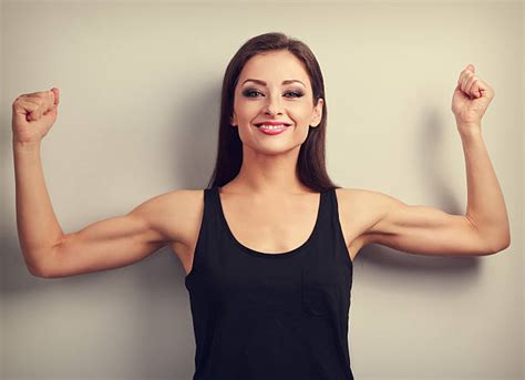 370 Young Woman Flexing Her Arm To Show Her Biceps Stock Photos