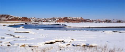 Body Of Water Surrounded By Snow Ground Under Blue Sky · Free Stock Photo