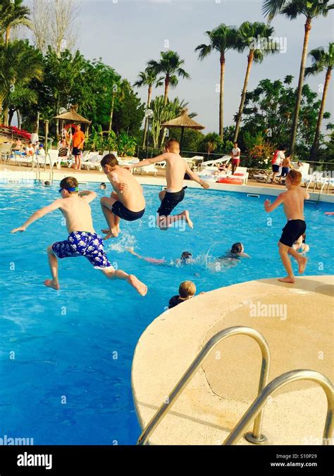 Boys Jumping In The Pool Stock Photo Alamy