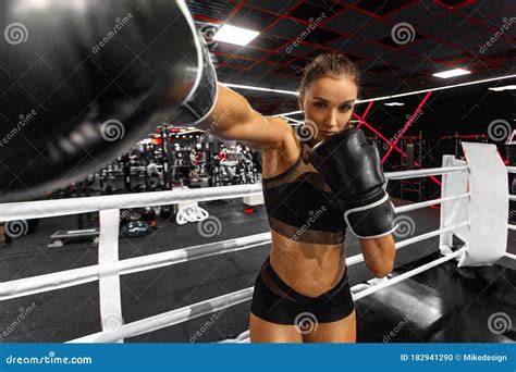 Woman Boxer In The Ring In The Gym Young Athlete In Boxing Gloves