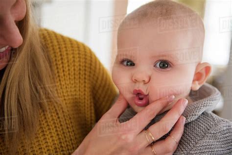 Mother Squeezing Baby S Face Stock Photo Dissolve