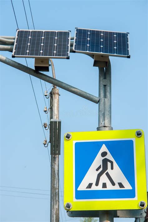 Pedestrian Crossing Sign Traffic Lights And Solar Panel On City Street