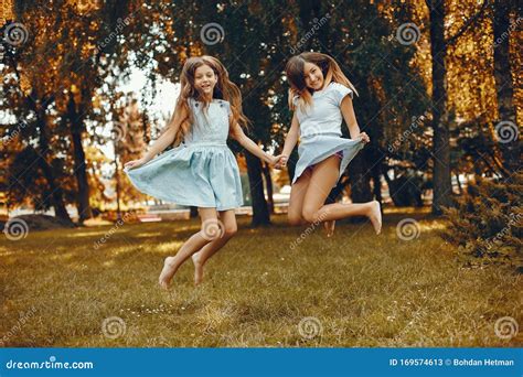 Two Cute Girls Have Fun In A Summer Park Stock Image Image Of Looking