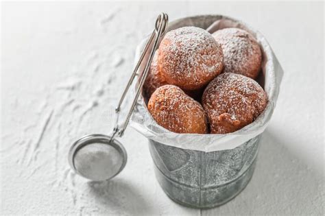 Delicious Donuts Balls With Powdered Sugar On White Table Stock Photo