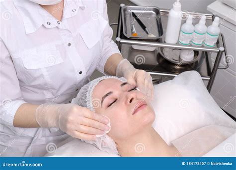 Beautician Makes The Cleansing Procedure A Young Beautiful Girl Patient
