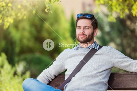 Handsome Young Man Sitting On Park Bench Royalty Free Stock Image