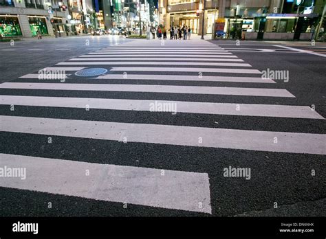 Men And Women Waiting To Cross Zebra Crossing In A Ginza Street Tokyo