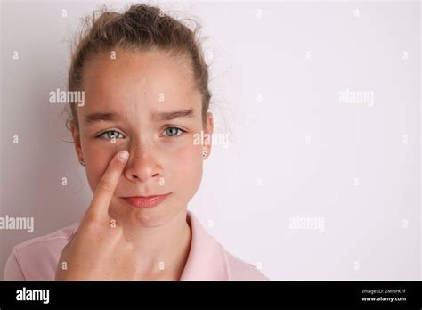 Little emotional teen girl in pink shirt 11, 12 years old on an
