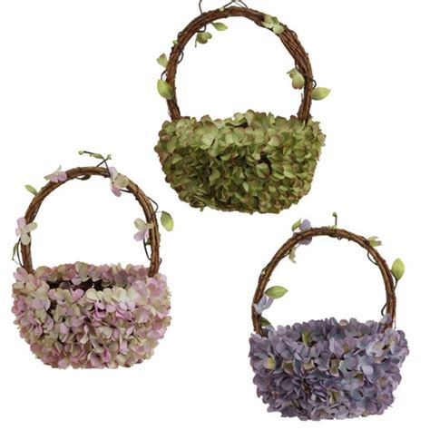 Three Baskets Filled With Flowers On Top Of Each Other