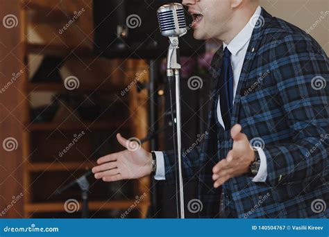 Retro Fifties Singer With Vintage Microphone And Sunglasses Studio