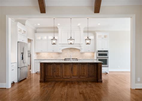 Gorgeous White Southern Style Kitchen With A Dark Wood Center Island