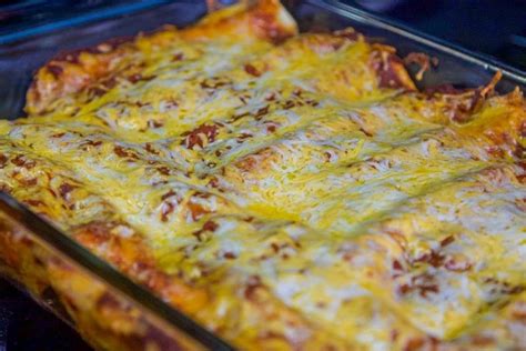 A Cheesy Casserole Dish With Cheese And Other Toppings On It