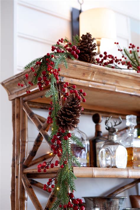 Garlands can be worn on the head or around the neck, hung on an inanimate object, or laid in a place of cultural or religious importance. How pretty does this red berry garland look draped over our bamboo bookcase. | Christmas ...