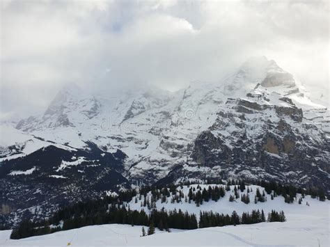 View Of The Swiss Mountains In Winter Eiger In Clouds Monoch And