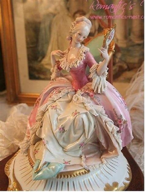 a figurine is sitting on top of a plate with a mirror in the background
