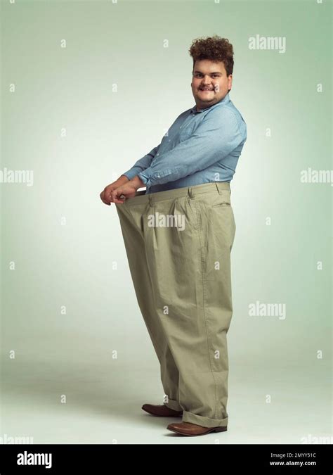 Wearing My Big Boy Pants An Overweight Man Wearing A Pair Of Oversized