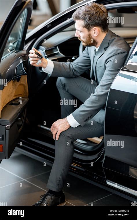Portrait Of A Handsome Businessman Sitting On The Driver Seat Of A