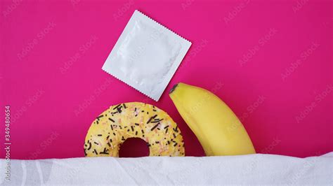 Sweet Donut And Banana On Pink Color Background Sex And Erotic Concept