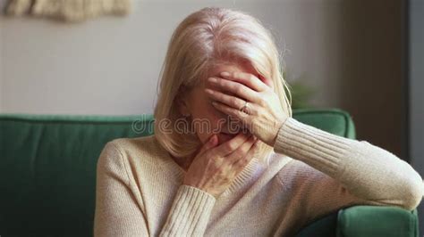 desperate sad grieving old widow crying covering face with hands stock footage video of