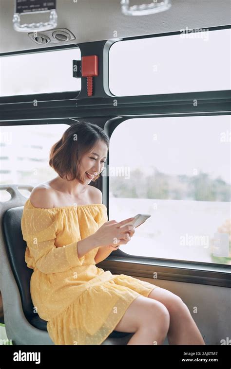 Asian Girl Using Phone On Public Bus Stock Photo Alamy