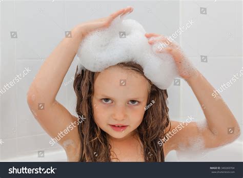 Cute Little Girl Having A Bath In Foam Water Child Washing Her Long