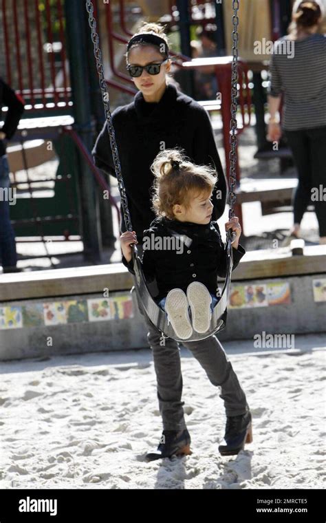 Actress Jessica Alba And Producer Cash Warren Play With Their Daughter Honor Marie On The Swings