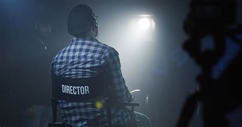 Director Sitting In His Chair On A Film Set Stock Photo Download
